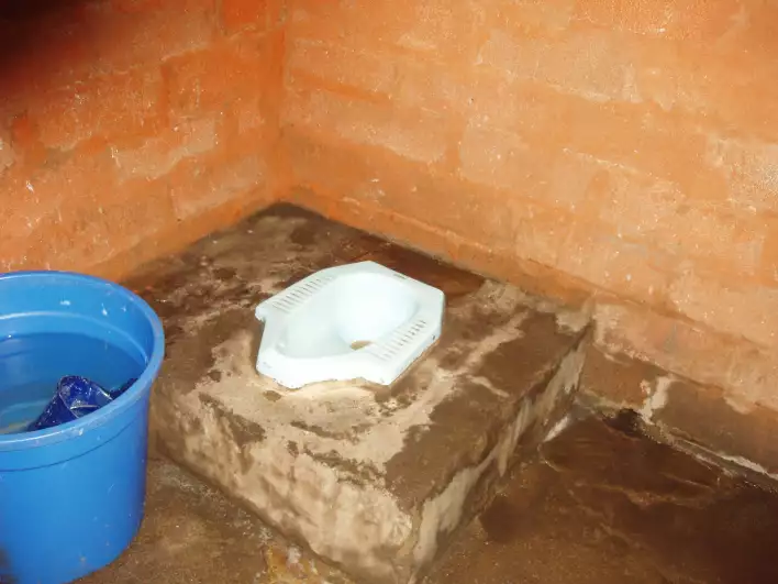 Another toilet, the water in the bucket serves as a toilet paper