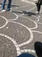 Sitting in front of the Pisa railway station and sightseeing people