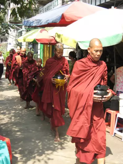 Monks on their way to beg some money