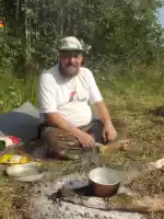 Santeri cooking tea with a flower hat on