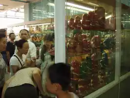 Tourists shopping wooden matushka dolls