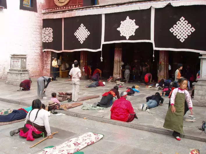 Yuan (Chinese money) pilgrims prostrating in front of Jokhang temple